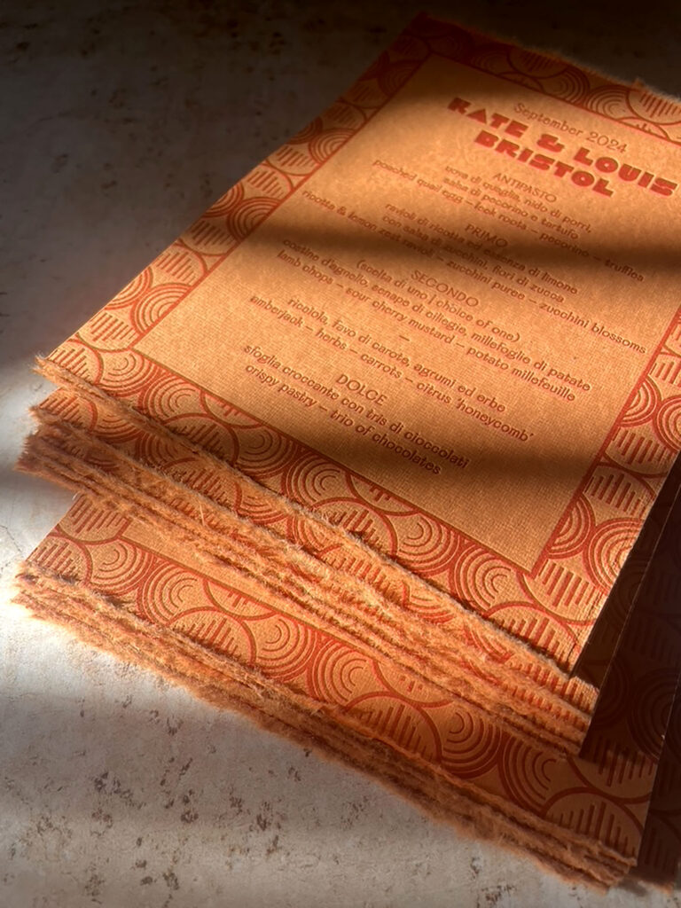 handmade orange paper letterpress printed menus by Bodega Press